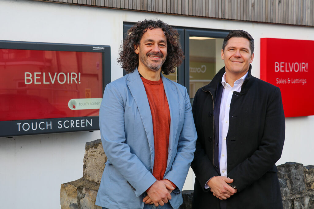 Nick Christofides, Director of The Greenroom managed property portfolio and Ben Davies, Managing Director of Belvoir Swansea in front of Belvoir Mumbles letting and estate agents. Belvoir sales and lettings logo on wall.